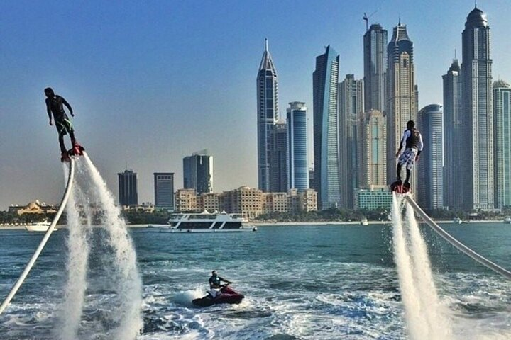 Soar above the waves in Dubai's breathtaking skyline gliding effortlessly on a flyboard. Experience exhilarating maneuvers while surrounded by iconic landmarks like the Burj Al Arab.